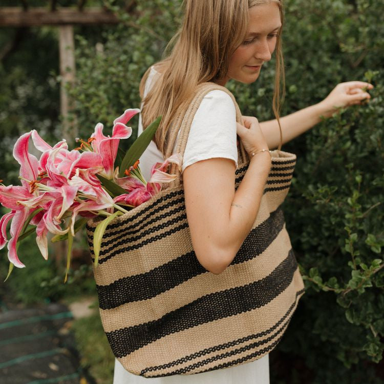 Stylish canvas tote bag with reinforced handles, perfect for groceries, beach items, and everyday essentials. The Breton Wide Market Shopper features a classic black and natural double stripe design, by Will & Atlas.