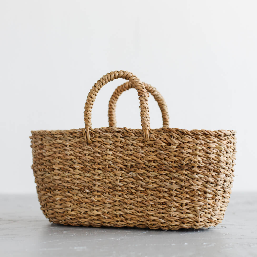 The Harvest gathering basket is handcrafted from hogla grass, an aquatic plant. Woven together, it creates a design that's both lightweight and strong, with layers of natural texture and tone.