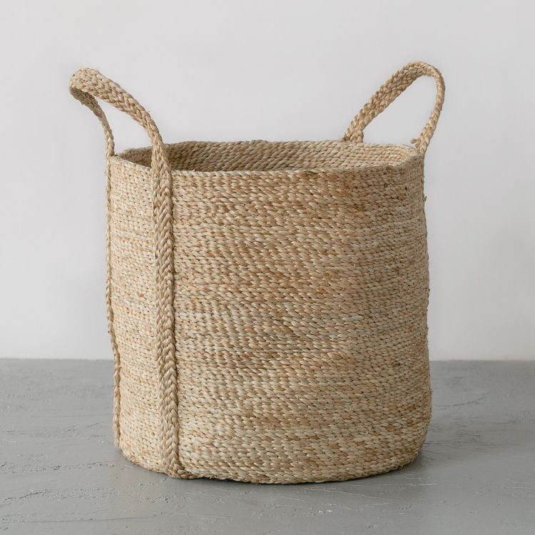 Handcrafted round jute laundry basket in natural, perfect for storing and transporting laundry, blankets, towels and other household items.