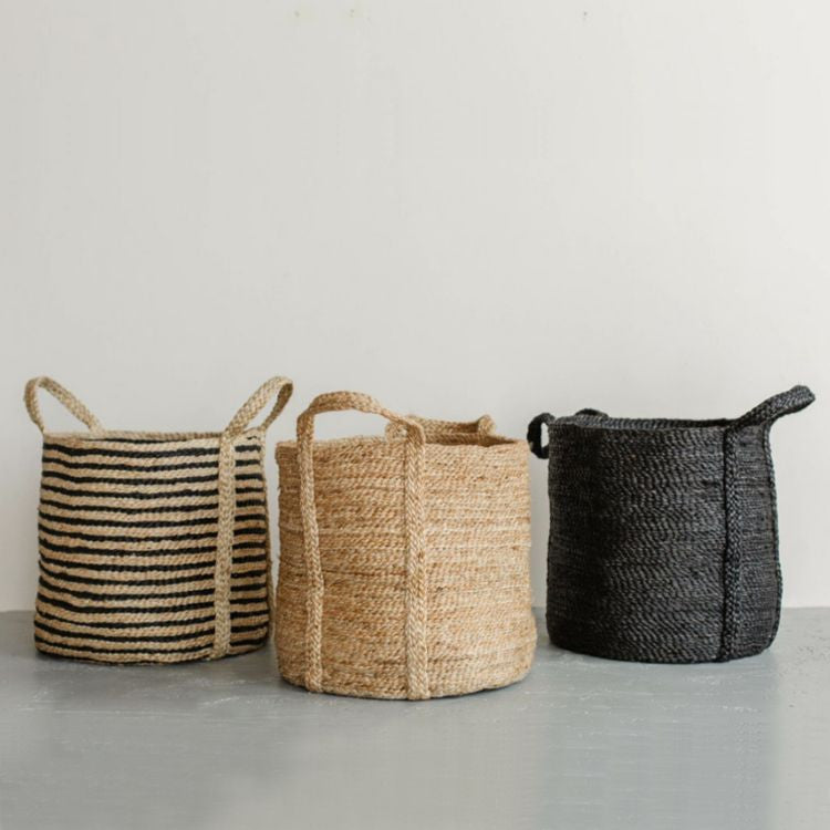 Handcrafted round jute laundry basket in natural, charcoal striped or charcoal, perfect for storing and transporting laundry, blankets, towels and other household items.