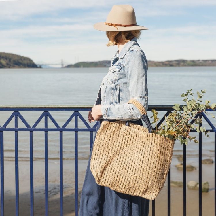 Our indigo stripe Jute Shopper is handcrafted with eco-friendly jute plant fibers and natural dyes. Our jute shopper is ready to accompany you on many an errand, from the grocery store to your favorite boutique. 