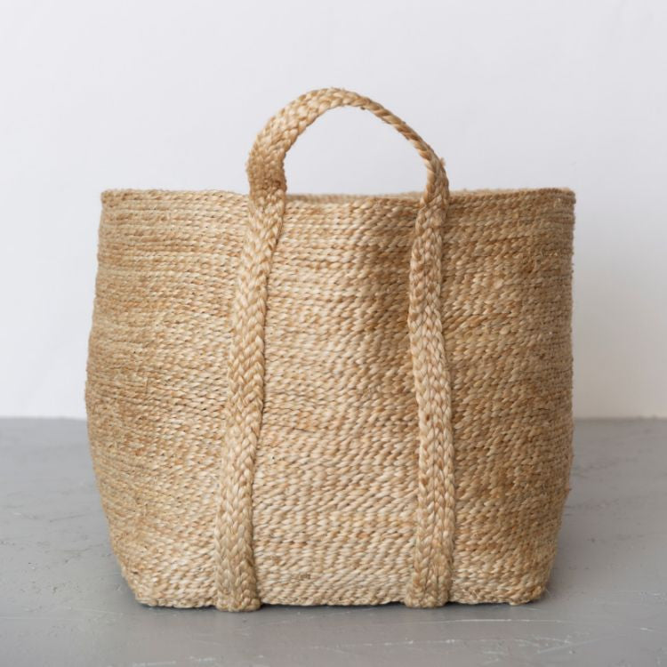A side view of our large, natural jute baskets deliver on both form & function. Expertly handwoven by women working within a Fair Trade program in Bangladesh, they are built to stand up to the demands of your busy household. 
