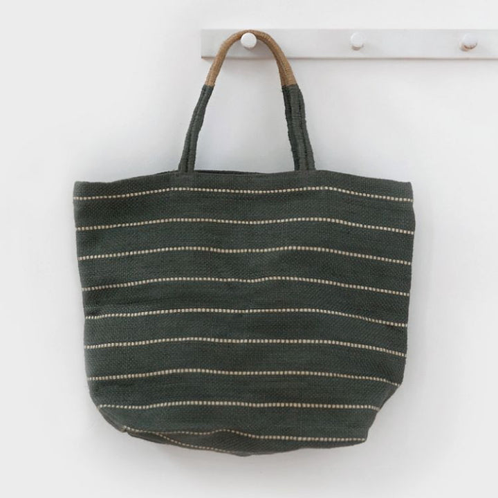 Handcrafted Marin jute shopper bag in slate grey with striped detailing and a woven, colorblocked handle, made using natural dyes and eco-friendly jute fibers from Bangladesh.