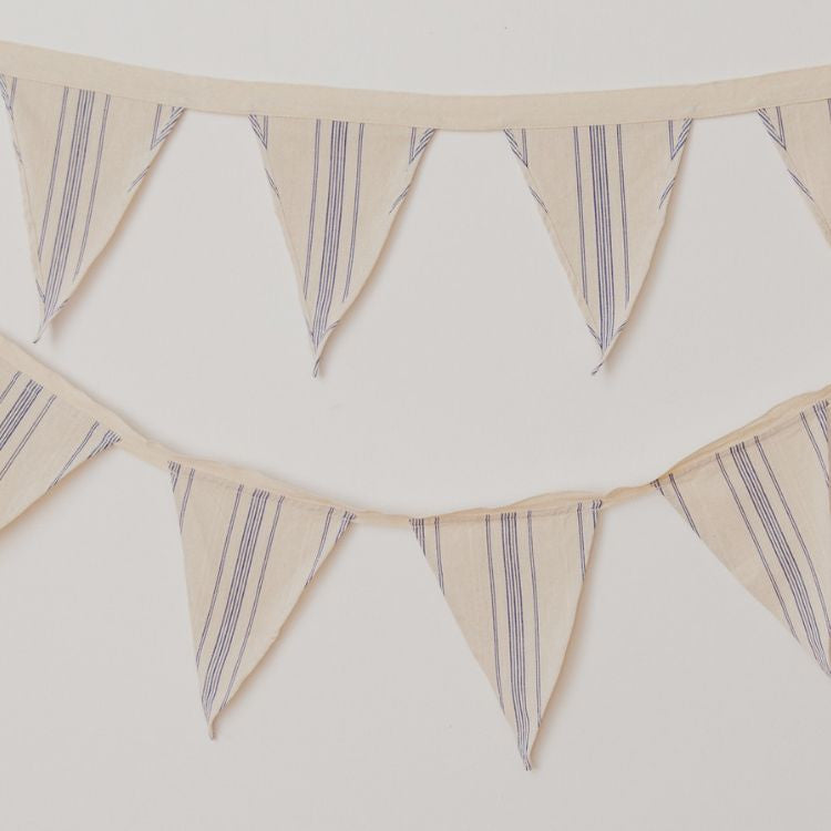 Handwoven natural cotton bunting with black or blue stripes, perfect for adding a whimsical touch to any space or soiree. Use to decorate your nursery or playroom, or display out in the garden for a picnic or birthday party.
