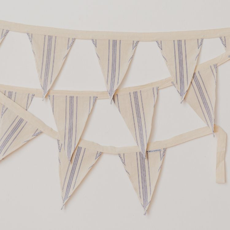Handwoven natural cotton bunting with black or blue stripes, perfect for adding a whimsical touch to any space or soiree. Use to decorate your nursery or playroom, or display out in the garden for a picnic or birthday party.