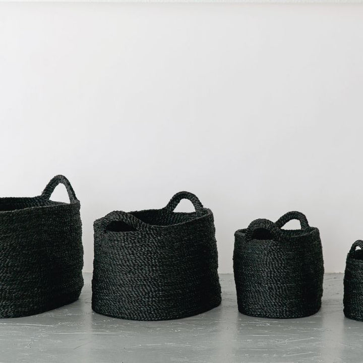 Handwoven Oval Jute Basket in charcoal, perfect for home organization and storage.

