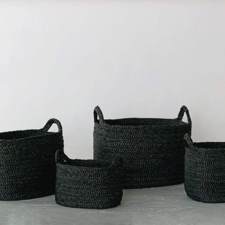 Handwoven Oval Jute Basket in charcoal, perfect for home organization and storage.

