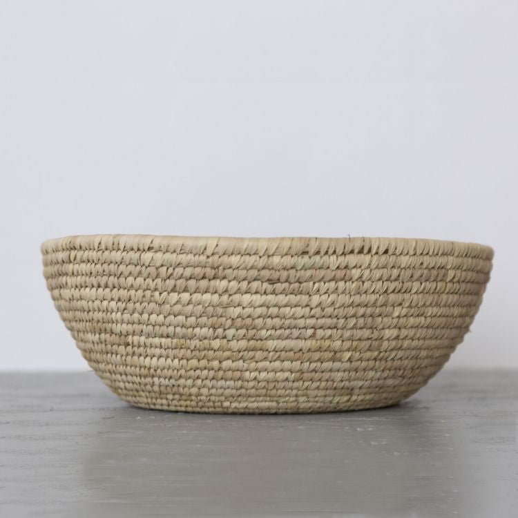 A handwoven jumbo palm leaf bowl with intricate texture and detailing, perfect for storage or decor, crafted sustainably in Bangladesh.