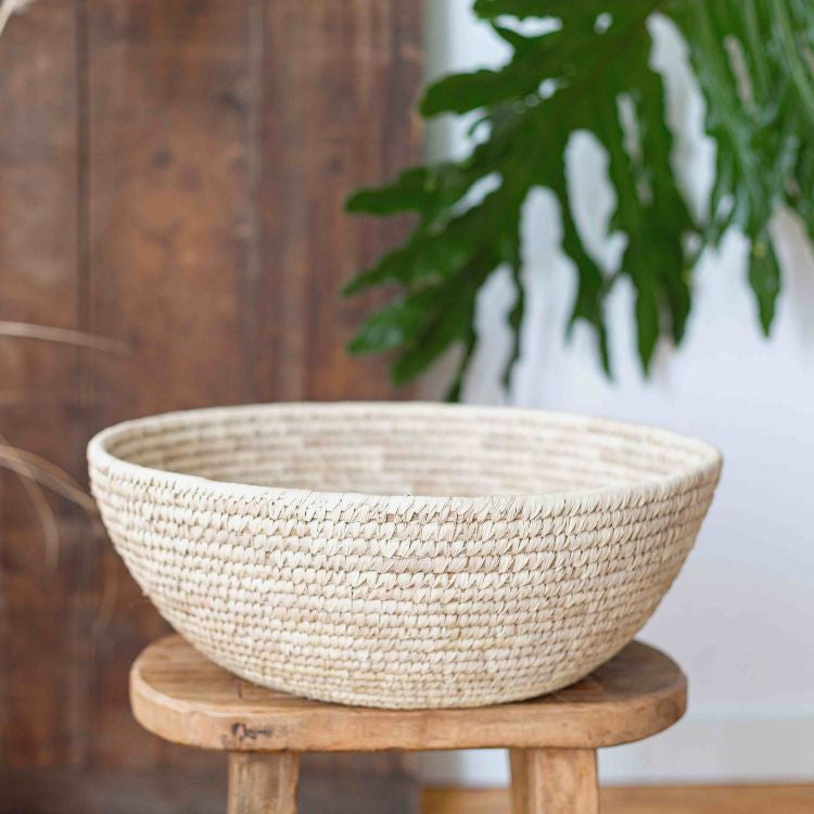 A handwoven jumbo palm leaf bowl with intricate texture and detailing, perfect for storage or decor, crafted sustainably in Bangladesh.