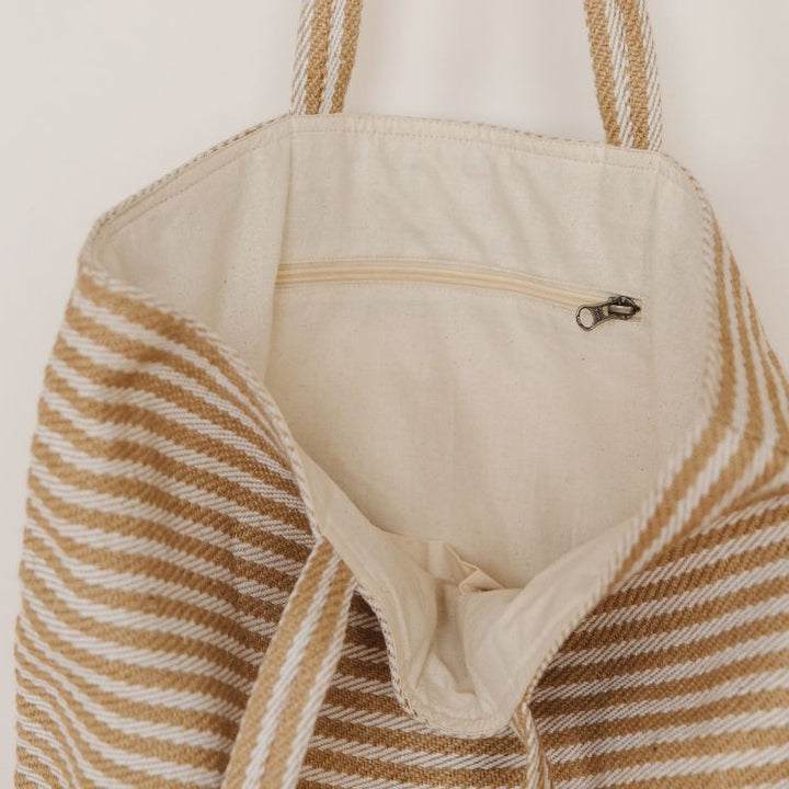 Our Paris striped tote bag is both totally practical and oh-so-chic. Handwoven jute tote bag in natural stripes, with sturdy handles and internal pockets, this oversized tote bag is perfect for busy shopping days or leisurely outdoor afternoons.