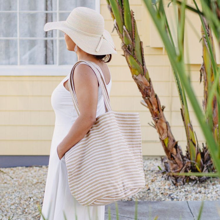 Our Paris striped tote bag is both totally practical and oh-so-chic. Handwoven jute tote bag in natural stripes, with sturdy handles and internal pockets, this oversized tote bag is perfect for busy shopping days or leisurely outdoor afternoons.