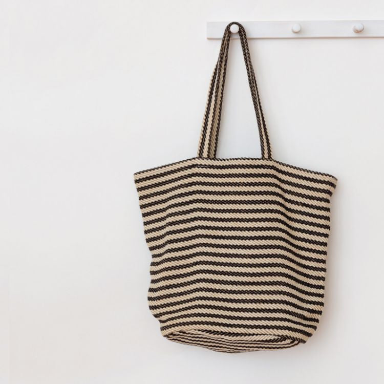 Our Paris striped tote bag is both totally practical and oh-so-chic. Handwoven jute tote bag in black stripes, with sturdy handles and internal pockets, this oversized tote bag is perfect for busy shopping days or leisurely outdoor afternoons.