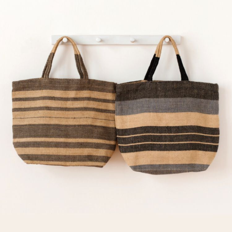 Our Indigo or Grey Striped Sonoma jute shoppers are not only super stylish, they’re a great way to meet your sustainability goals. These fair trade bags are handwoven and dyed with natural dyes by skilled artisans using natural jute fiber, making them a durable and eco-friendly alternative to single-use bags.