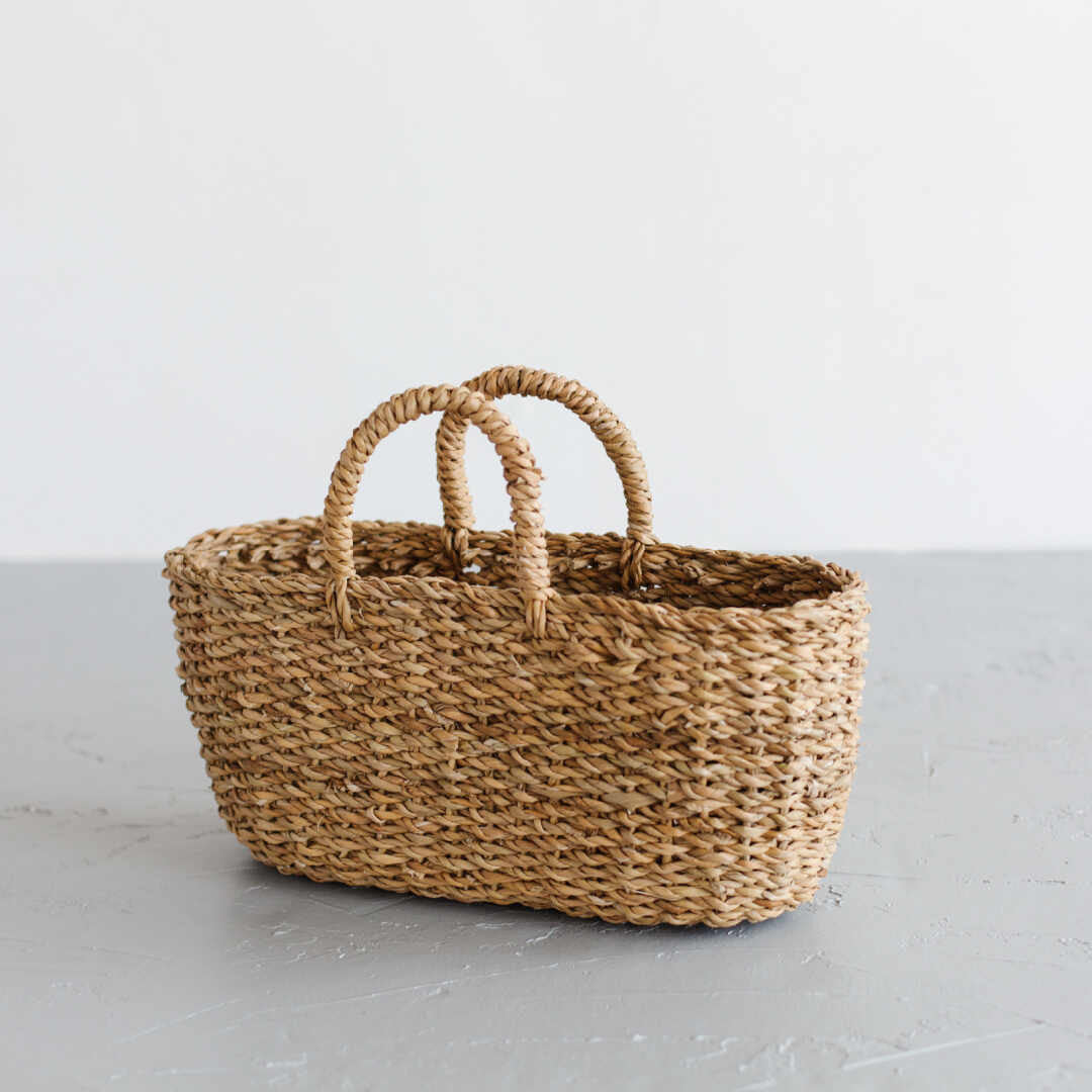 The Harvest gathering basket is handcrafted from hogla grass, an aquatic plant. Woven together, it creates a design that's both lightweight and strong, with layers of natural texture and tone.