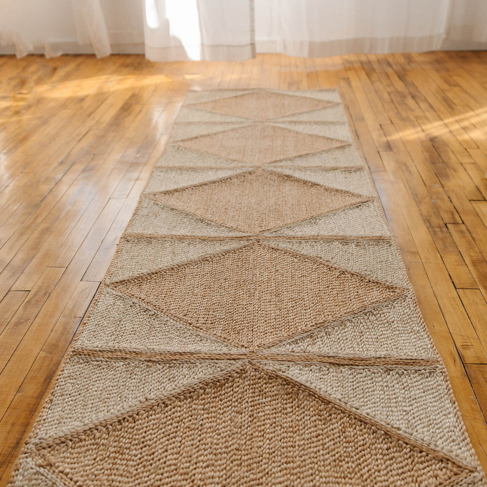 Our  jute runners are truly a work of love, and a work of art! Each of the squares in our rugs is handcrafted by our artisan partners in Bangladesh , then each piece is sewn  together in a gorgeous geometric pattern. These fair trade rugs are available in two other sizes, medium & large, ensuring the perfect fit for your space.