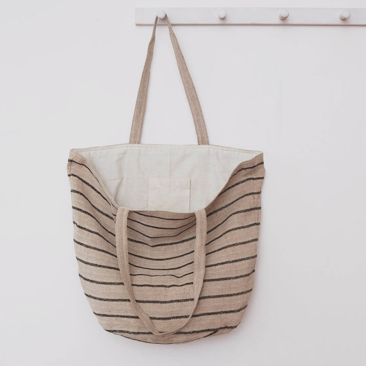 Our Chloe striped tote bag is both totally practical and oh-so-chic. Handwoven jute tote bag in black stripes, with sturdy handles and internal pockets, this oversized tote bag is perfect for busy shopping days or leisurely outdoor afternoons.