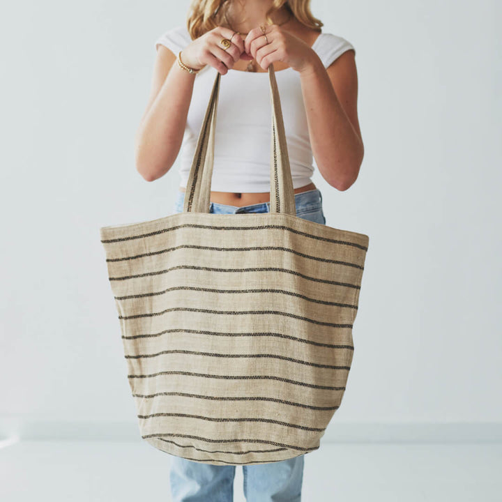 Our Chloe striped tote bag is both totally practical and oh-so-chic. Handwoven jute tote bag in black stripes, with sturdy handles and internal pockets, this oversized tote bag is perfect for busy shopping days or leisurely outdoor afternoons.