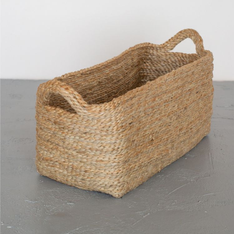 Handwoven jute rectangle tray baskets in natural. Perfect for organizing shelves, displaying beauty products, or lining up succulent pots. Impeccably crafted with meticulous detail by Will & Atlas.