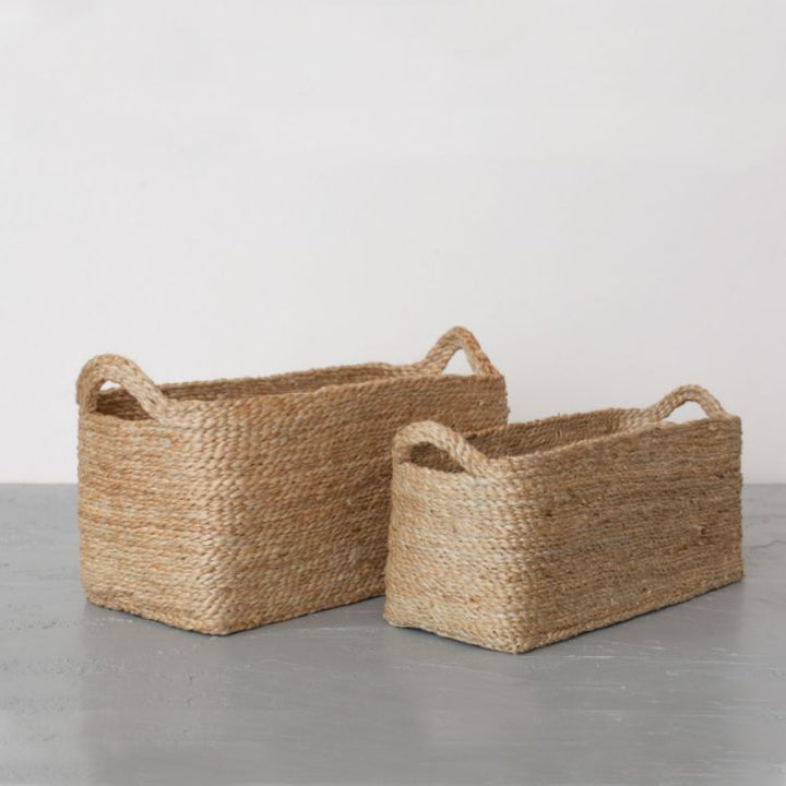 Handwoven jute rectangle tray baskets in natural and charcoal. Perfect for organizing shelves, displaying beauty products, or lining up succulent pots. Impeccably crafted with meticulous detail by Will & Atlas.