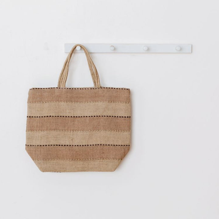 Eco-friendly spice colored jute tote bag with reinforced handles, perfect for groceries, beach items, and everyday essentials. The Khari Market Shopper are hand woven with traditional techniques and are stylish and practical.