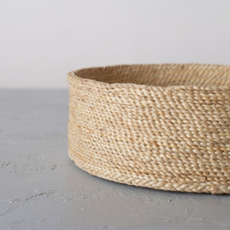 Single handwoven natural jute basket, perfect for storing household items and adding natural texture to your decor.