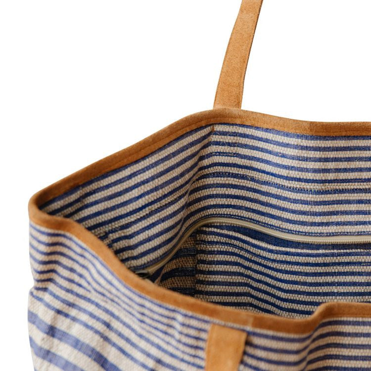 Spacious Paloma Collection striped totes with durable suede handles and zipper closure. Available in black or indigo striped detailing and natural jute fiber. Stylish and versatile accessory from Will & Atlas.