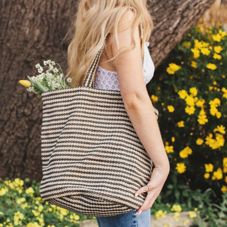 Our Paris striped tote bag is both totally practical and oh-so-chic. Handwoven jute tote bag in black or natural stripes, with sturdy handles and internal pockets, this oversized tote bag is perfect for busy shopping days or leisurely outdoor afternoons.