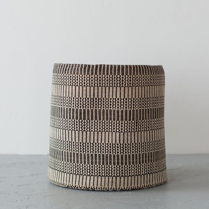 Single handwoven round storage basket in Kalied pattern, perfectly suited for an array of purposes, like storage for winter gear, a catch-all for laundry, or as a cozy nest for your child’s stuffed animals. Offered in three sizes, small, medium and large. 