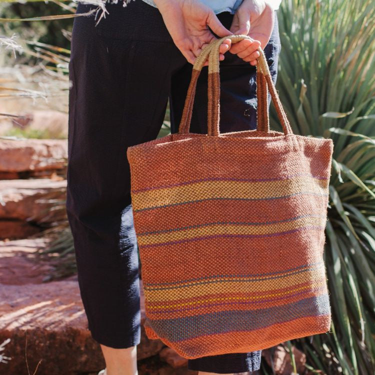 Eco-friendly jute tote bag with reinforced handles, perfect for groceries, beach items, and everyday essentials. The Sedona Market Jute Shopper features a stylish beige and black striped design, by Will & Atlas.