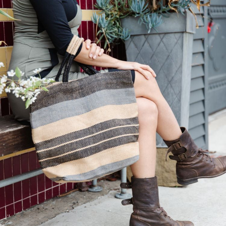 Our Indigo Striped Sonoma jute shoppers are not only super stylish, they’re a great way to meet your sustainability goals. These fair trade bags are handwoven and dyed with natural dyes by skilled artisans using natural jute fiber, making them a durable and eco-friendly alternative to single-use bags.
