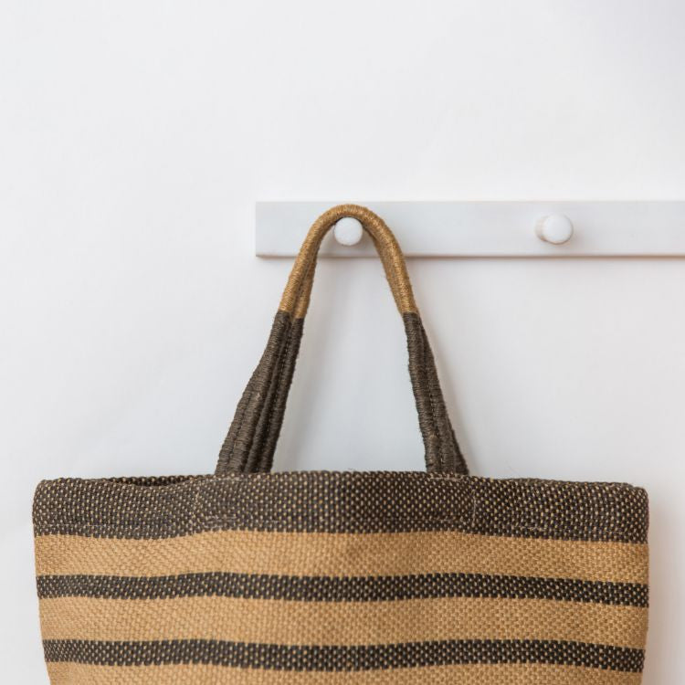 Our Grey Striped Sonoma jute shoppers are not only super stylish, they’re a great way to meet your sustainability goals. These fair trade bags are handwoven and dyed with natural dyes by skilled artisans using natural jute fiber, making them a durable and eco-friendly alternative to single-use bags.