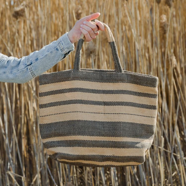 Our Grey Striped Sonoma jute shoppers are not only super stylish, they’re a great way to meet your sustainability goals. These fair trade bags are handwoven and dyed with natural dyes by skilled artisans using natural jute fiber, making them a durable and eco-friendly alternative to single-use bags.