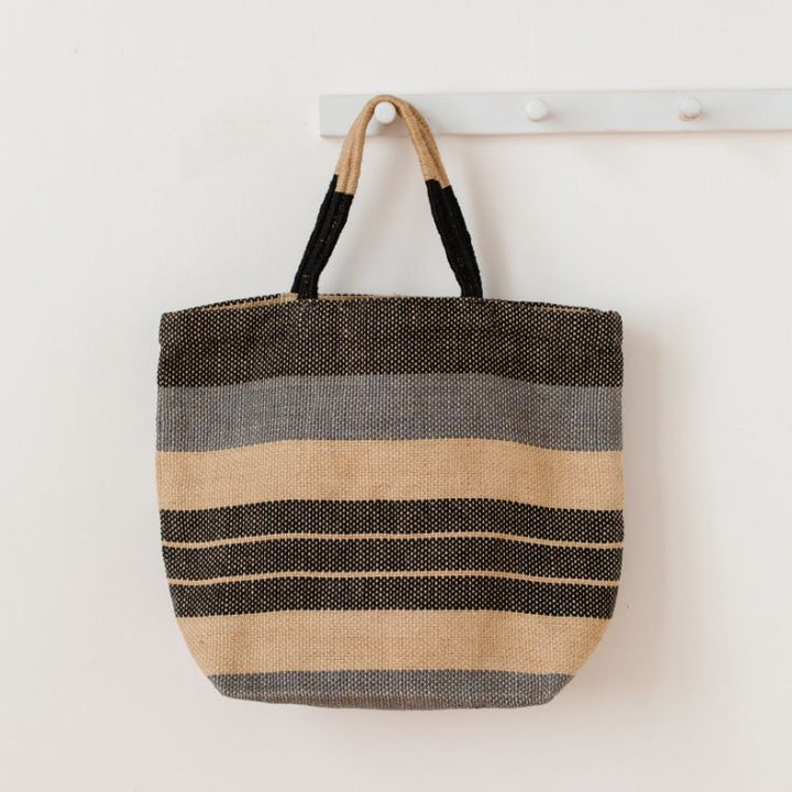 Our Indigo Striped Sonoma jute shoppers are not only super stylish, they’re a great way to meet your sustainability goals. These fair trade bags are handwoven and dyed with natural dyes by skilled artisans using natural jute fiber, making them a durable and eco-friendly alternative to single-use bags.
