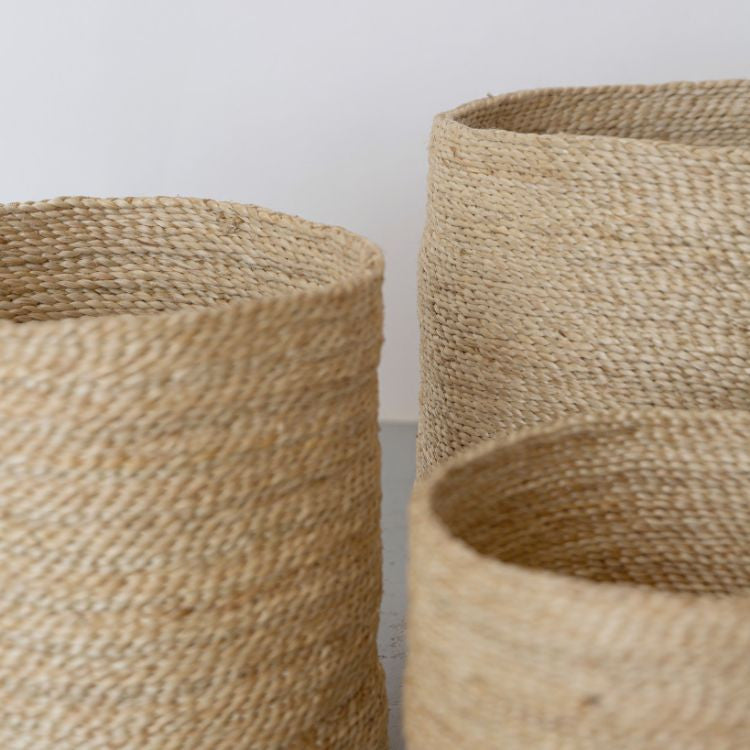 Detail of handwoven tall round jute baskets set of 3, natural texture and tone, sustainable and eco-friendly, available in 3 sizes.