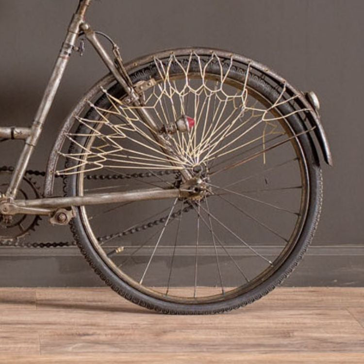A charming vintage French bicycle in a child's or ladies' size, featuring an antique design with intricate details and rustic appeal. Perfect for adding nostalgic elegance to your interior decor.