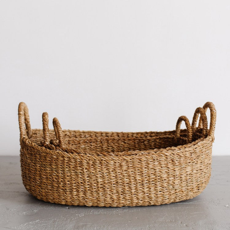 We love the way the light dances on our Harvest baskets! From rich chestnut to golden brown, the hues and tones are simply gorgeous. Our Harvest baskets are handwoven with hogla grass, an aquatic plant. Like jute, hogla grass is knows for its durability and natural beauty. Each basket features double handles for easy carrying.

